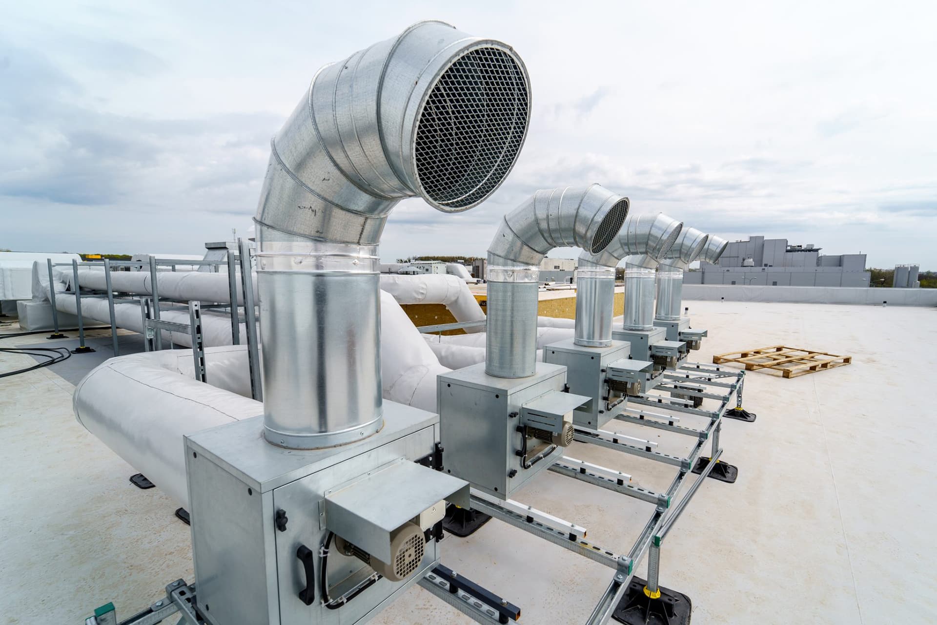 Rooftop ventilation system with metal ducts.