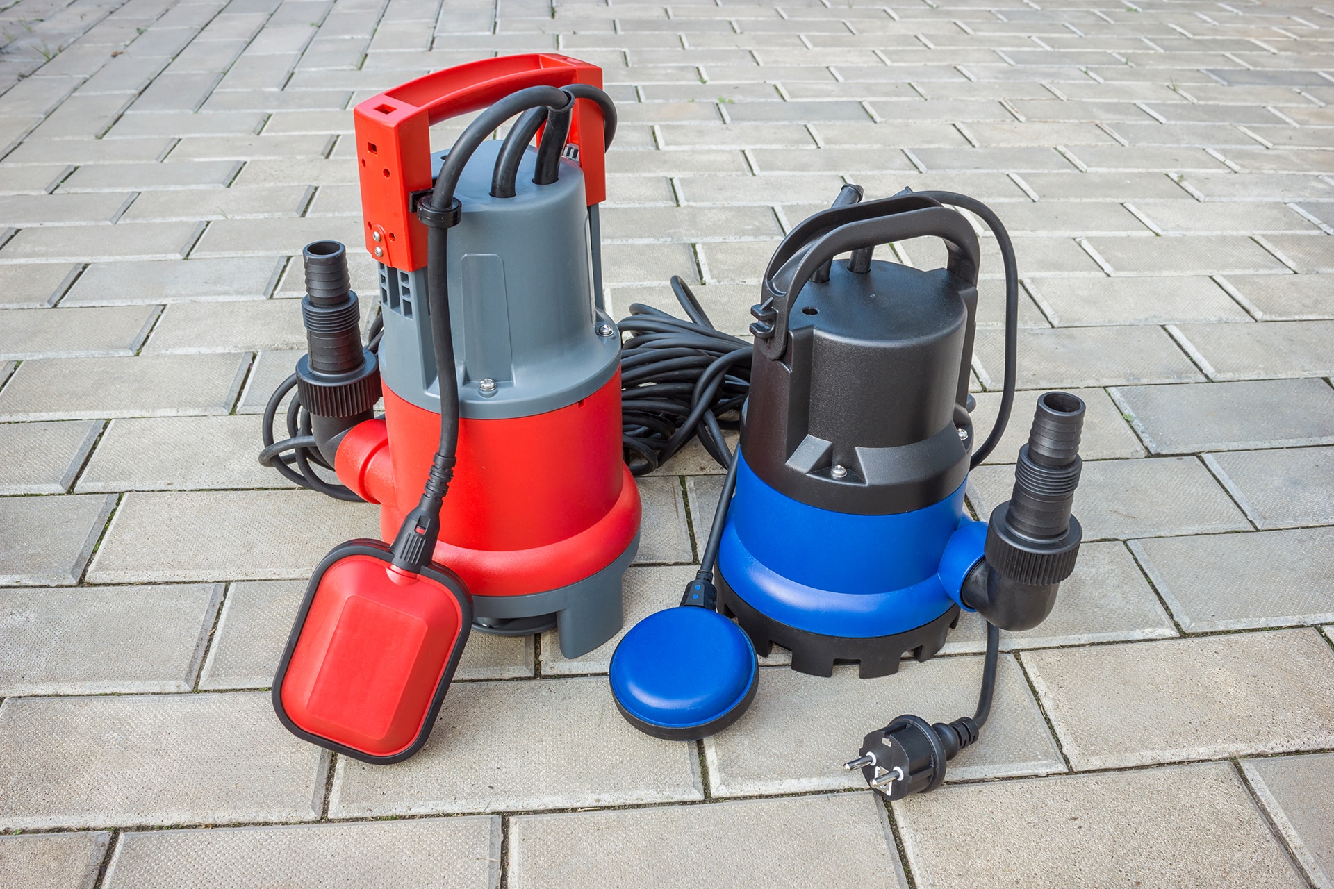 Submersible water pumps on stone pavement