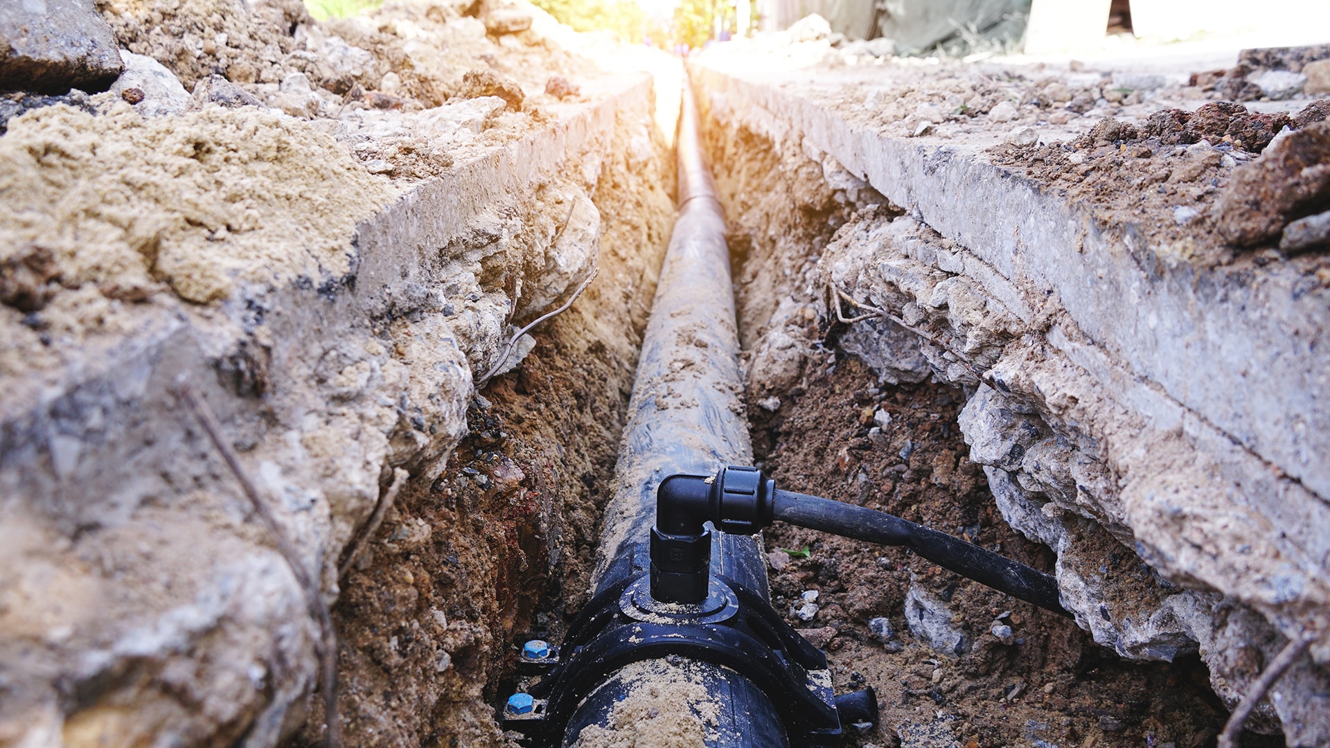 Underground pipeline installation in trench construction site