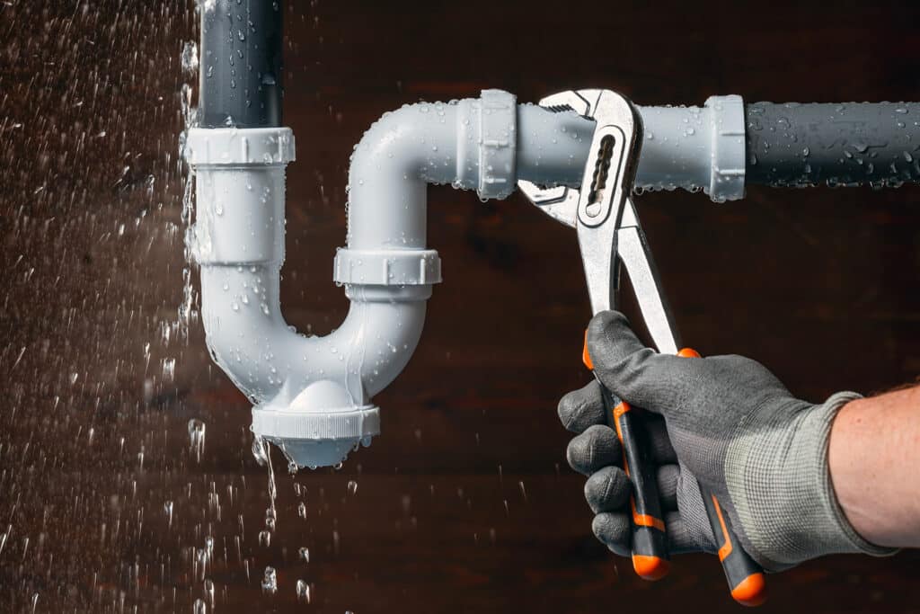 Fixing a leaky pipe with a wrench