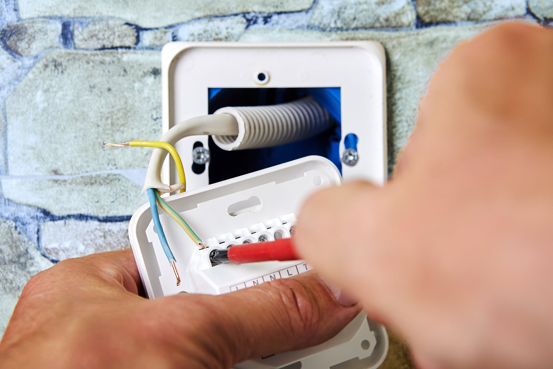 Installing electrical wires into a wall socket