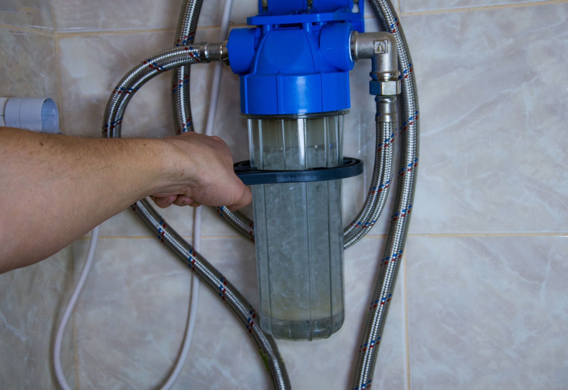 Person installing a water filter system